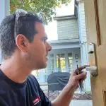 Tamir checking handle of new residential door lock installed