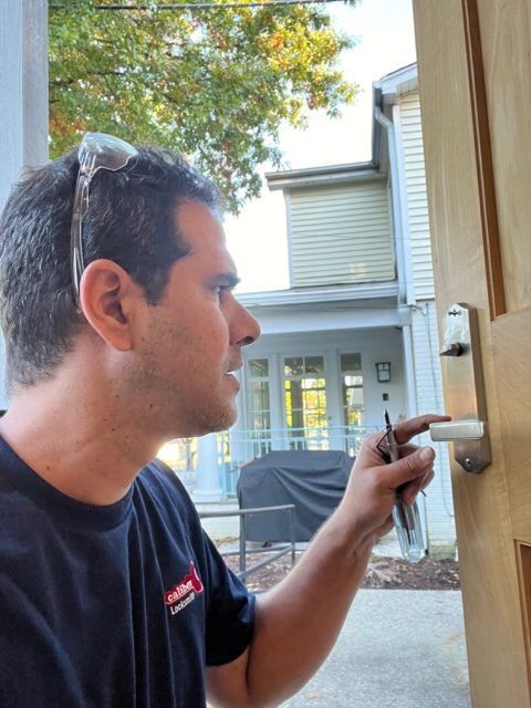 Tamir checking handle of new residential door lock installed